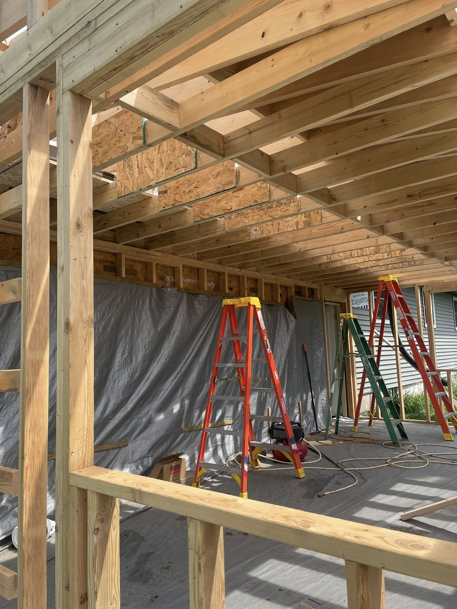 Construction addition showing wooden framing and structural work